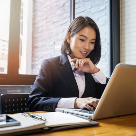 Businesswoman working at desk on laptop