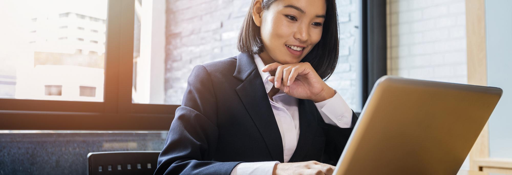 Businesswoman working at desk on laptop